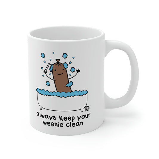 white mug with brown hot dog with brush in white bathtub with blue  bublles